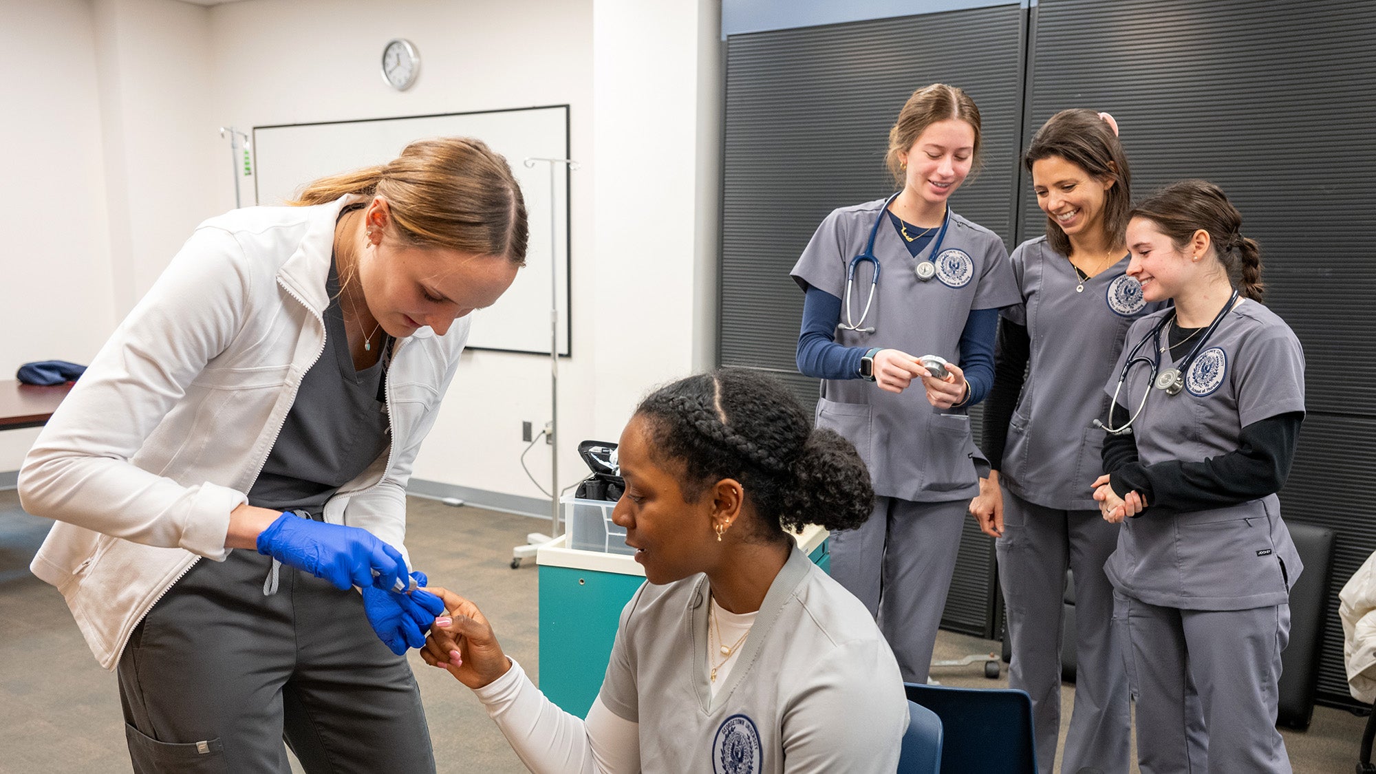 Students work with each other in the Sim Lab